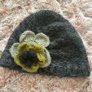 Super cute knit hat with flower detail.